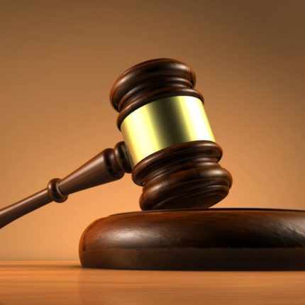 brown wooden mallet in upright position with gold coating